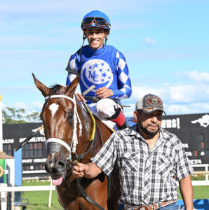 Florida-bred Thoroughbred Tessellate is led towards the camera after winning the 2025 Juvenile Fillies Sprint at Gulfstream Park. Still in the saddle, jockey Edgard Zayas smiles at the camera as they head to the winners circle. (Photo: ©SV Photography)