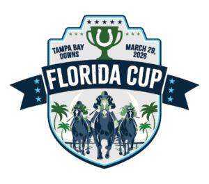 Badge logo for the 2026 Florida Cup at Tampa Bay Downs. The badge consists of a trophy centered at its top, with a horseshoe overlaid on top of the cup and “Tampa Bay Downs,” “March 29, 2026,” flanking its left and right sides respectively. There’s a ribbon cutting across the center of the badge that reads, “Florida Cup,” in all capital letters, and an illustration of three horses galloping beneath the ribbon.