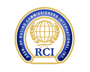 Horseshoe-shaped badge logo for RCI. The logo is outlined in gold, with a navy blue band running along the inside of the “shoe” that features all capitalized lettering spelling out the full name of the organization, “Assn. of Racing Commissioners International, Inc.” In the middle of the shoe, an outlined globe in gold, framed by fronts, is centered over the blue letters of “RCI.”