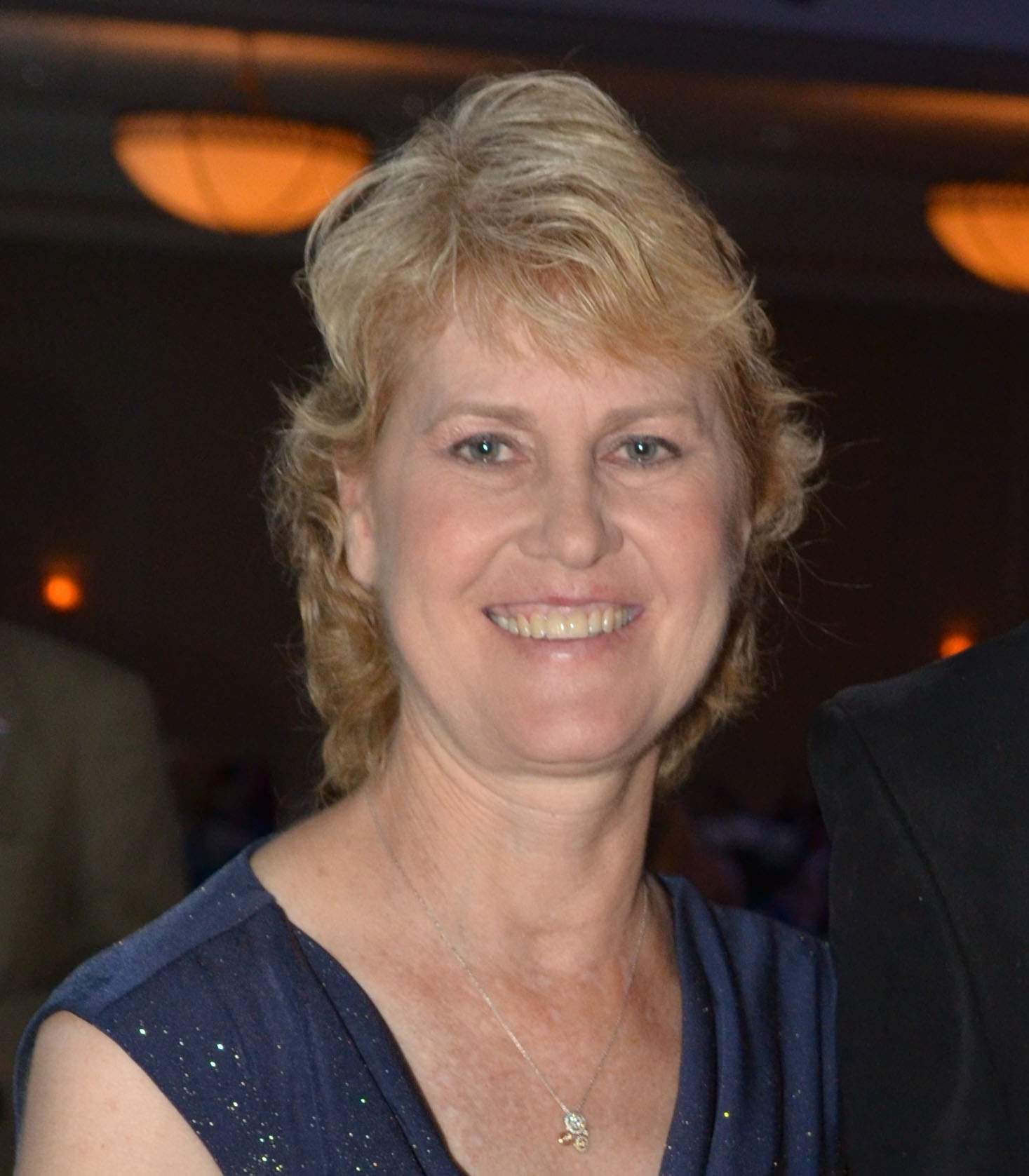 Closely cropped headshot of Florida Thoroughbred breeder Courtney Meagher, who smiles at the camera. (Photo by ©Nevarez)