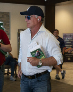 Photo of Bloodstock agent Donato Lanni turned (presumably) towards the auction ring while holding the 2026 OBS Spring catalog. (Photo: ©OBS/VidHorse Photo)