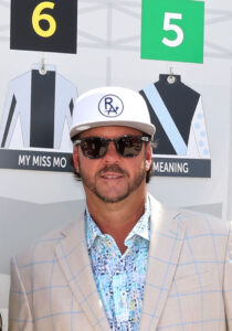 Headshot of Rich Averill standing in front of the sign for Florida-bred My Miss Mo’s Kentucky Oaks post position. (Photo by ©Coady Media) 
