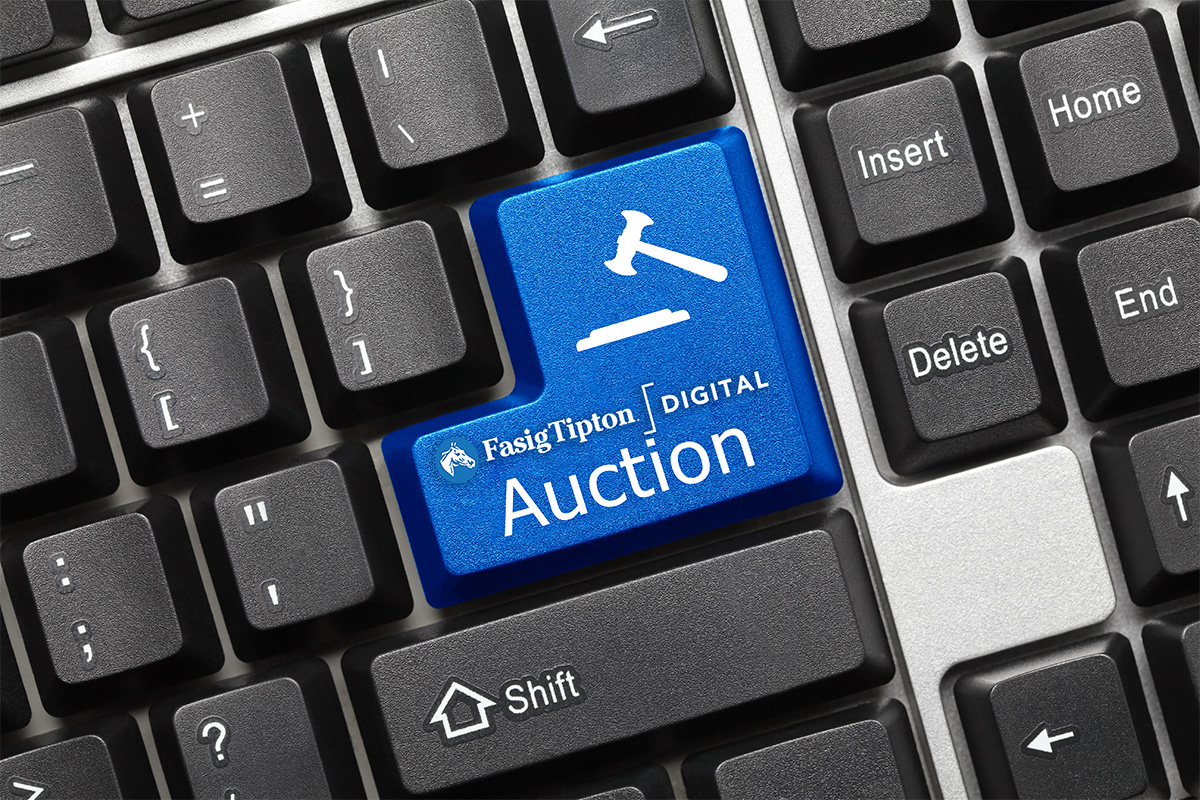 Close up image of a black keyboard with a large, bright blue key that has a minimized symbol of a white auction gavel, which is placed above the Fasig-Tipton Digital Sale logo, and the word, “Auction.” (Original Photo: ©Artem Sam)