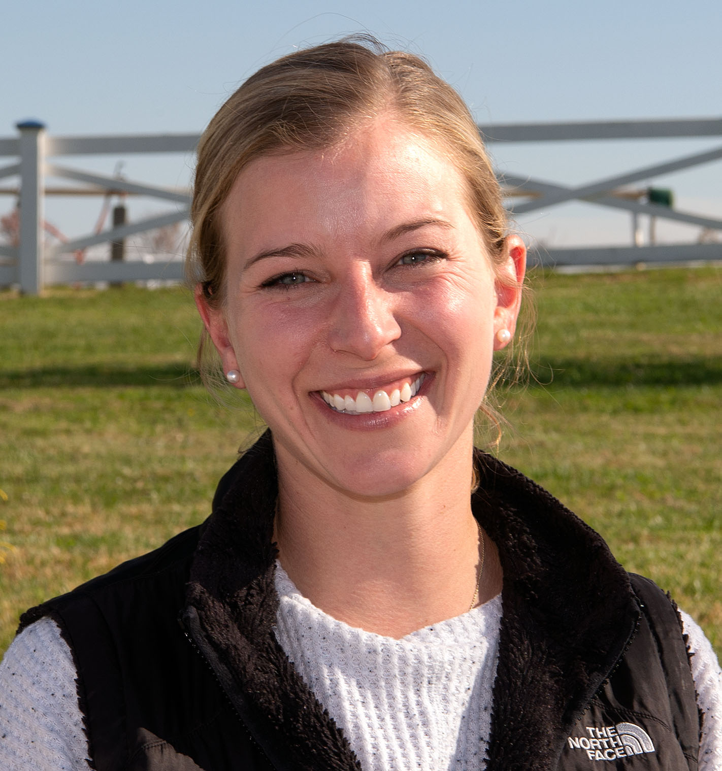 Headshot of Thoroughbred trainer Brittany Russell smiling for the camera. (Photo: ©Jim McCue)