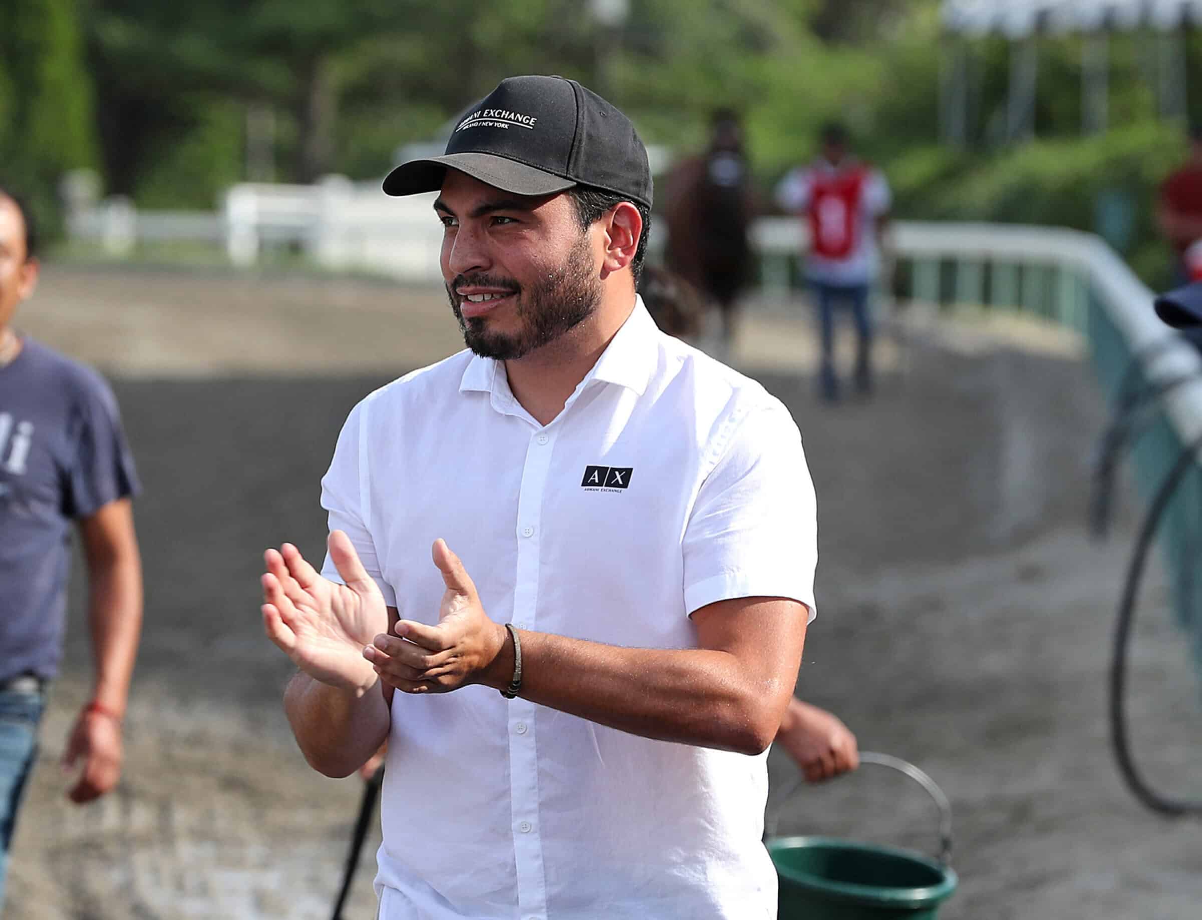Photo of racehorse trainer Jorge Delgado claps trackside after Winfromwithin #8 with Carlos Rojas riding won the $100,000 Red Bank Stakes at Monmouth Park Racetrack in Oceanport, NJ on Monday September 5, 2022. (Photo: ©Bill Denver/EQUI-PHOTO)