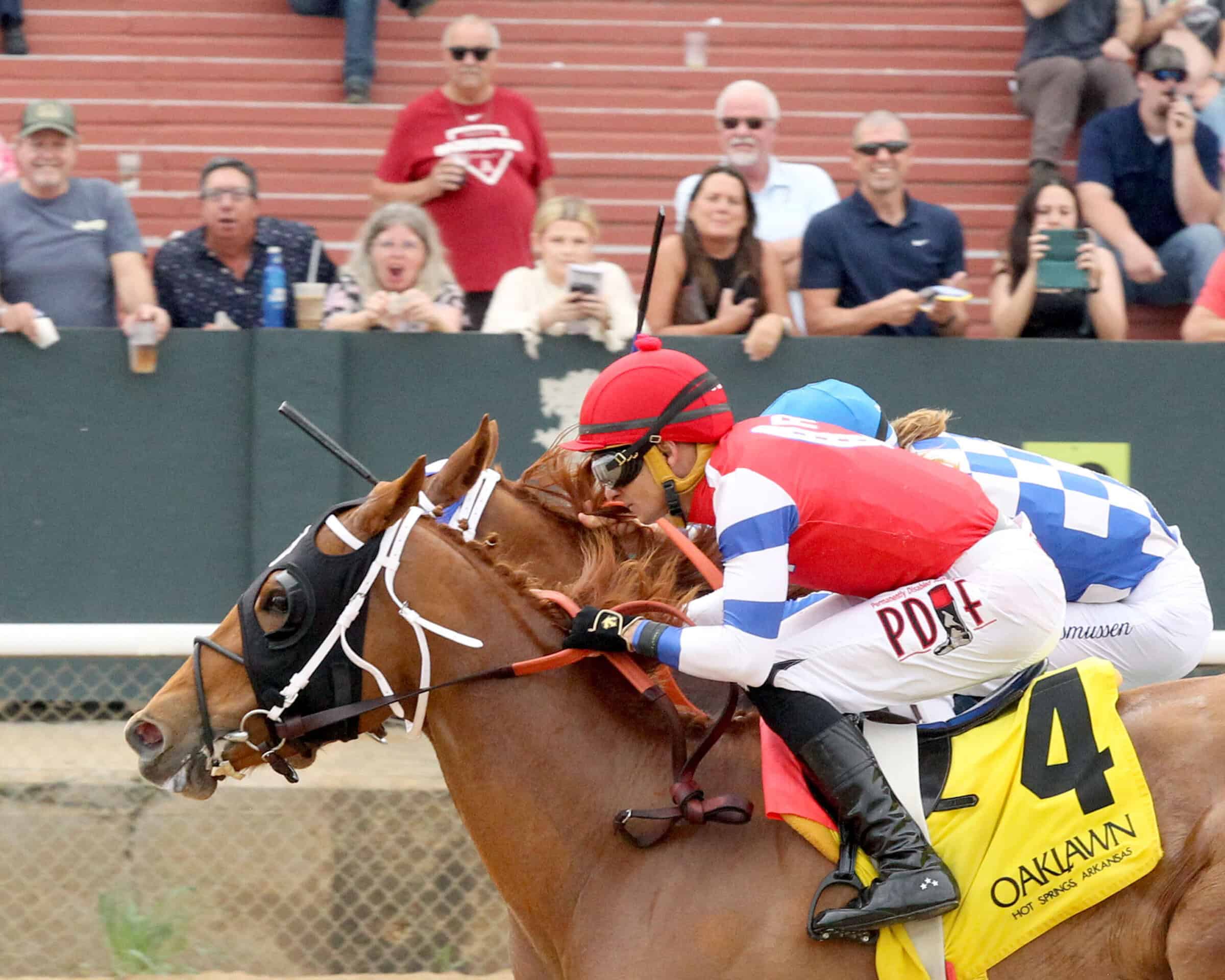 Closely cropped photo of Florida-bred Spring Dancer and jockey Francisco Arrieta galloping to the wire on the inside rail, sticking a head in front of outside competition Anakarina. Spring Dancer and Arrieta held the lead to with the 2026 Majestic Overnight Stakes at Oaklawn Park. (Photo: ©Jean Lozada/Coady Media)