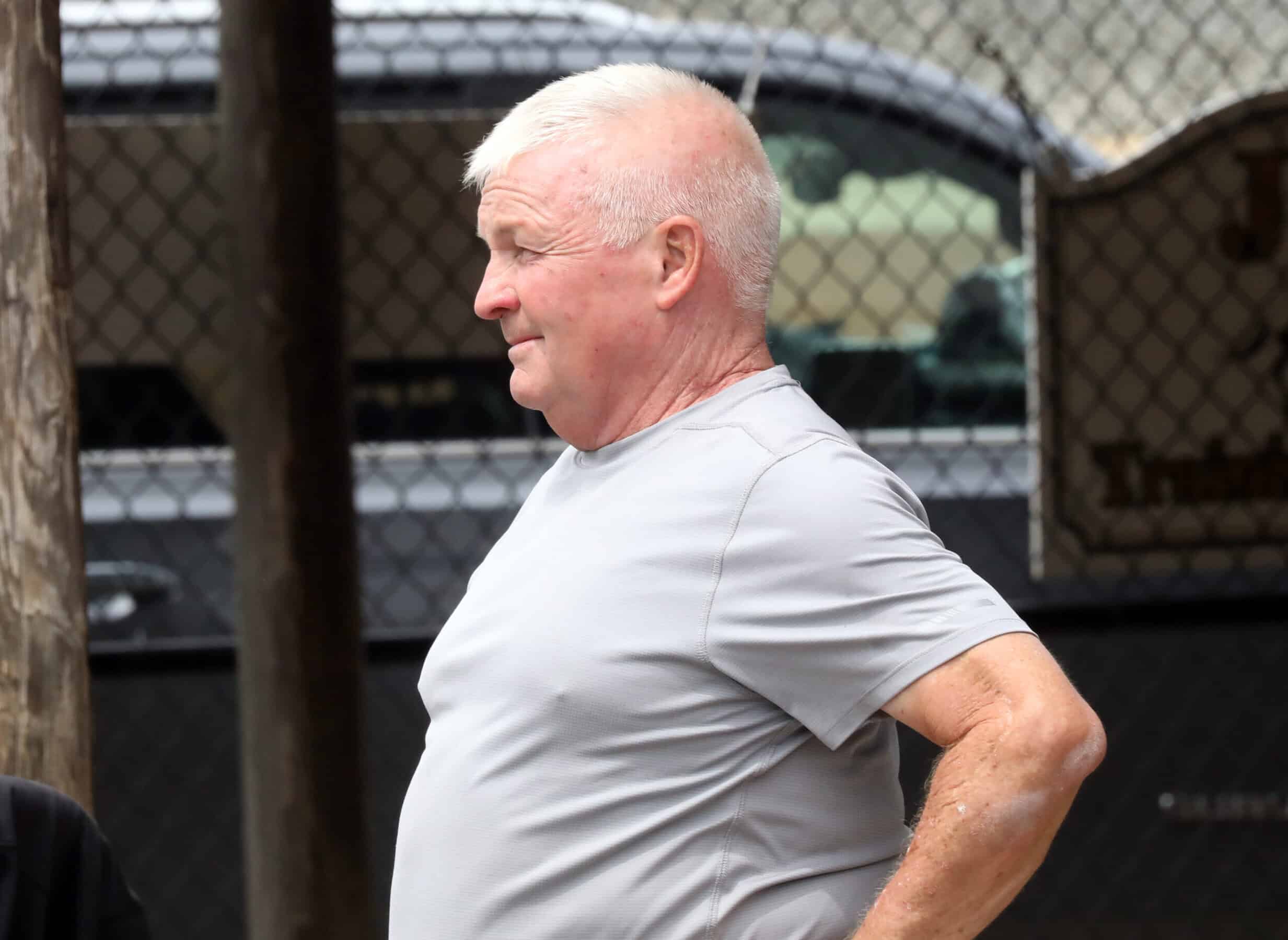 Tom McCrocklin stands behind the barns of Fasig-Tipton during the 2023 Fasig-Tipton Midlantic 2 Year-Old-in Training Sale, looking away from the camera. (Photo: Fasig-Tipton)