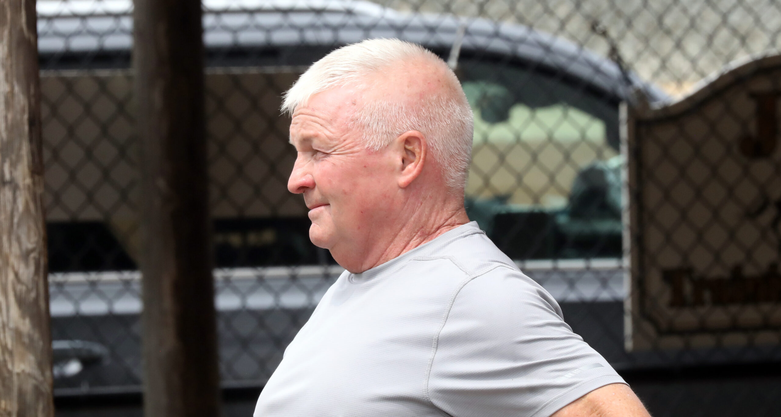 Tom McCrocklin stands behind the barns of Fasig-Tipton during the 2023 Fasig-Tipton Midlantic 2 Year-Old-in Training Sale, looking away from the camera. (Photo: Fasig-Tipton)