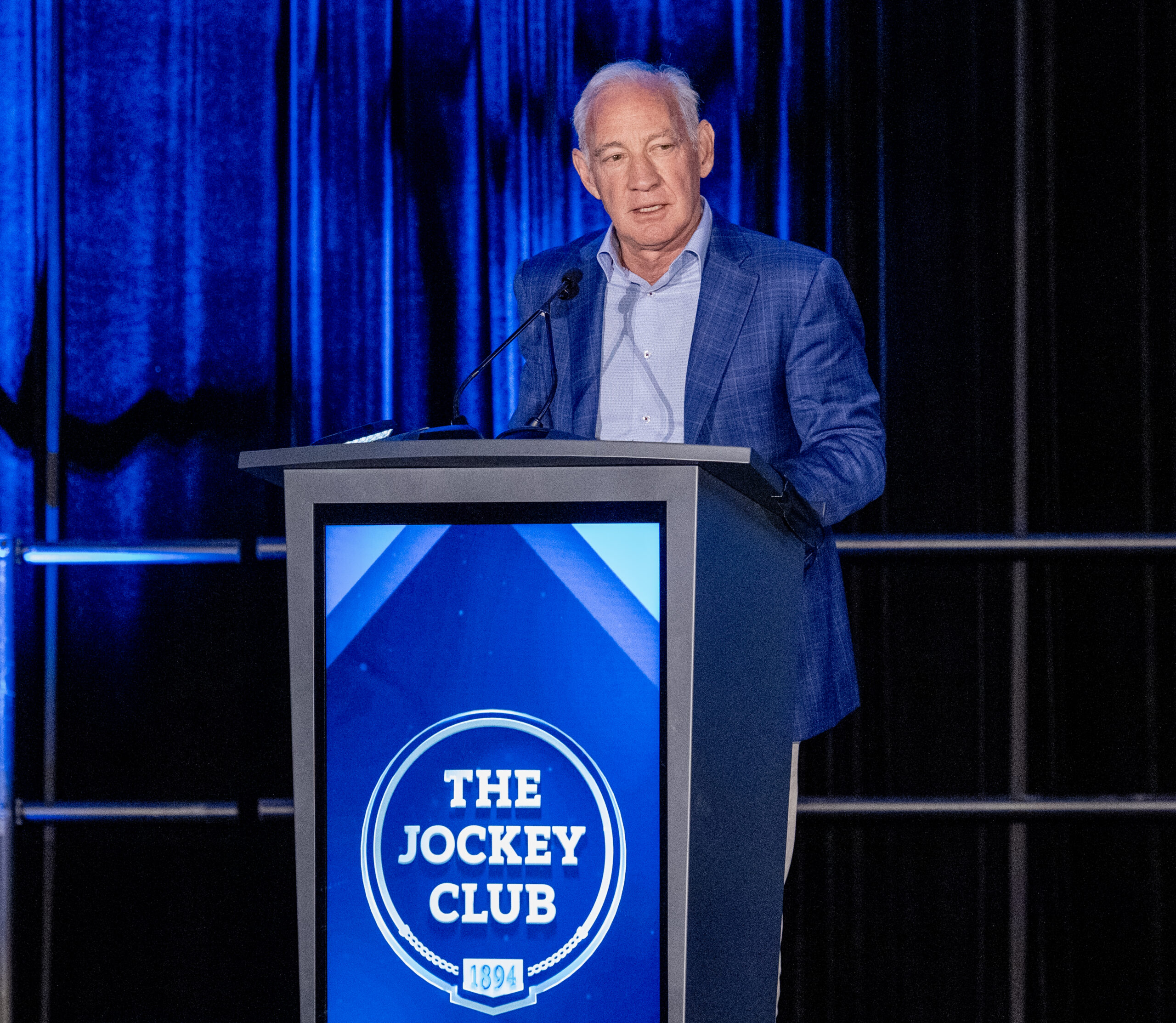 Greg Maffei, CEO of BANN Ventures and co-founder and chair of Horse Racing League, addresses the audience from the podium of The Jockey Club’s 74th Annual Round Table Conference on Matters Pertaining to Racing. (Photo: ©The Jockey Club)