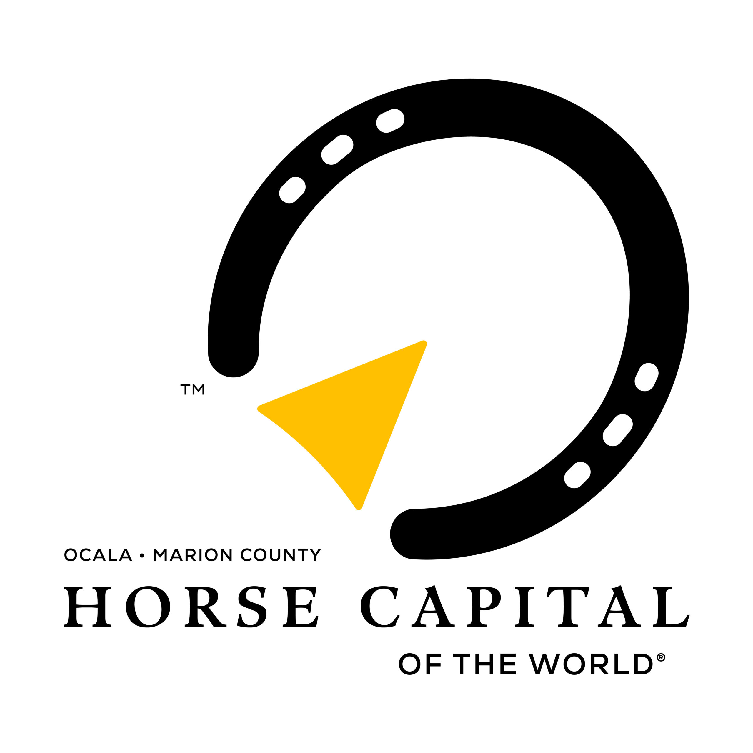 Logo for the Horse Capital of the World®. The logo consists of a black horseshoe pointing to the right. Within it, a yellow arrow doubles as the “frog” of a horse’s hoof, furthering the directional point. Beneath the logo mark, stacked, serif text reads, “Ocala • Marion County, Horse Capital of the World®.”