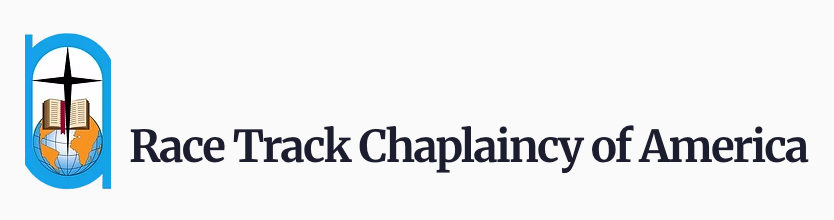 Logo for the Race Track Chaplaincy of America, featuring the full name of the organization in a serif font. To the left of the name, a pointed Cross overlaps an open Bible, which is placed upon a globe. The stacked graphic is encircled by a blue outline, mimicking a horse racetrack.