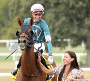 A happy Keith Asmussen on Laigina is greeted after the race by his wife Andie Biancone Asmsussen