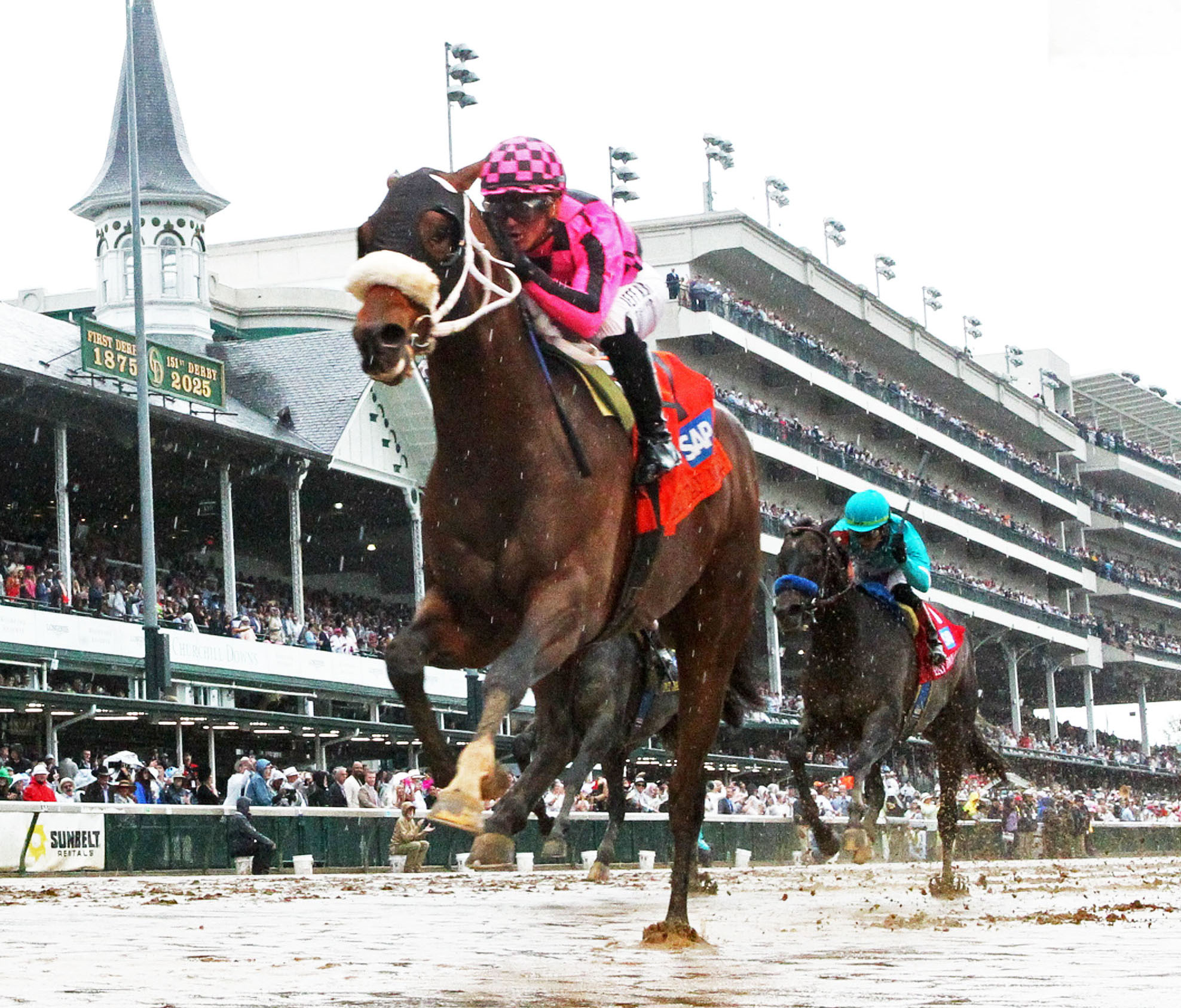 Florida-bred Thoroughbred Macho Music and jockey Javier Castellano rocket to the wire on the inside rail over a sloppy and sealed track. The duo outlasted against competitors Gaming (far outside) and Madaket Road (middle), winning the 2025 Pat Day Mile (Grade 2) at Churchill Downs. (Photo: ©John Gallagher / Coady Media)