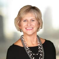 Professional headshot of Valerie Dailey against a blurred background.