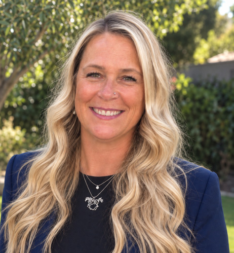 Headshot of Dr. Laurie Bohannon, smiling for the camera on a sunny day. (Photo Courtesy: The Jockey Club)