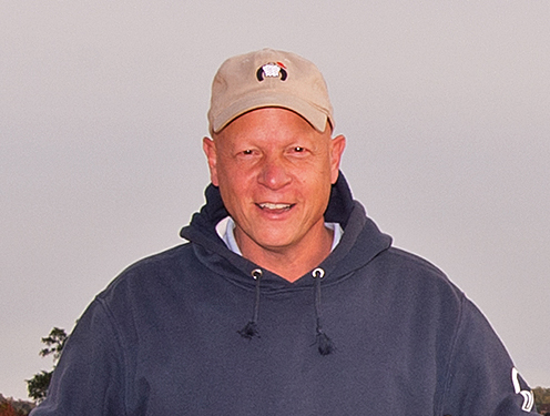Candid headshot of Thoroughbred trainer, Michael Trombetta, smiling at the camera. (Photo: ©Jim McCue)